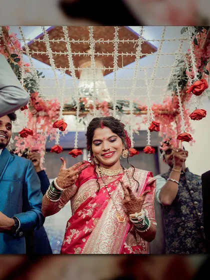 The bride takes center stage on the dance floor. Her energetic pose and happy expression capture the fun and festive mood of the reception.