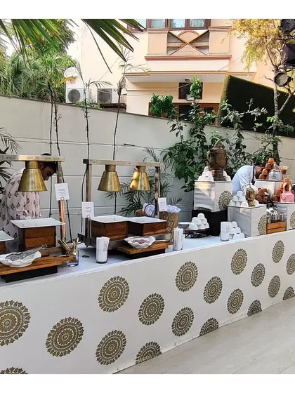 A beautifully styled buffet line for a winter high tea, featuring elegant table linens and a clean, organized setup for hot and cold items.