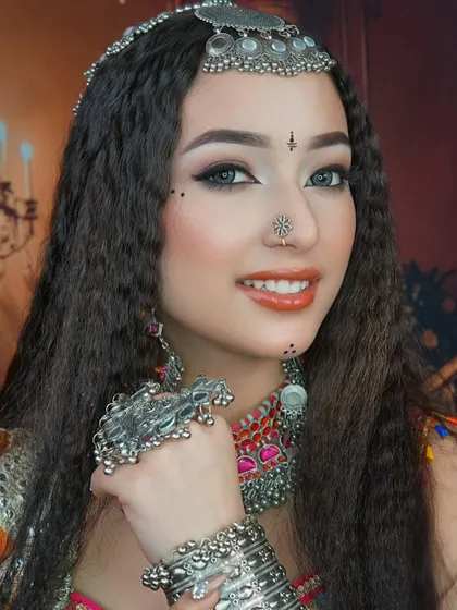 Another angle showing the beautiful winged eyeliner and the delicate bindi work that completes this festive look.