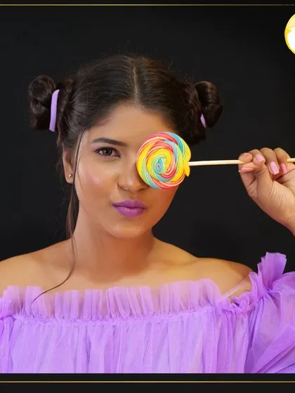 This playful look features a monochromatic purple theme, from the eyeshadow to the lipstick. It's a great example of the creative photoshoot makeup I teach, complete with fun styling.