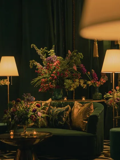 Another view of the emerald lounge, where deep green velvet, gold cushions, and rich floral arrangements came together for a look of pure opulence.