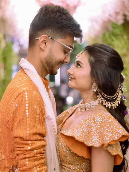 "And it was all yellow," or in this case, a beautiful orange. This couple's portrait captures the love and joy of the Haldi ceremony, with the bride looking absolutely radiant.