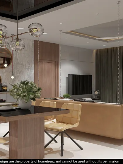 This view from the dining table looks towards the living area, showcasing the hanging bubble-style chandelier and the comfortable, modern furniture.