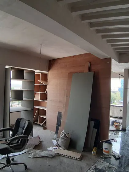 An office or study room in the making. You can see the framework for the library shelving and the coffered ceiling design being implemented.