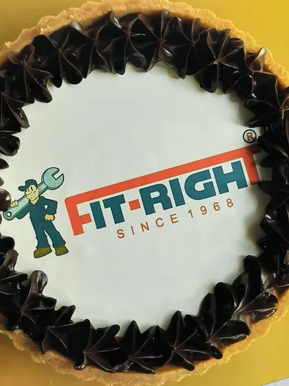 Another angle of the custom logo chocolate tart, showing the clean, crisp edible print surrounded by decadent chocolate piping. It's a professional and delicious way to represent your brand.