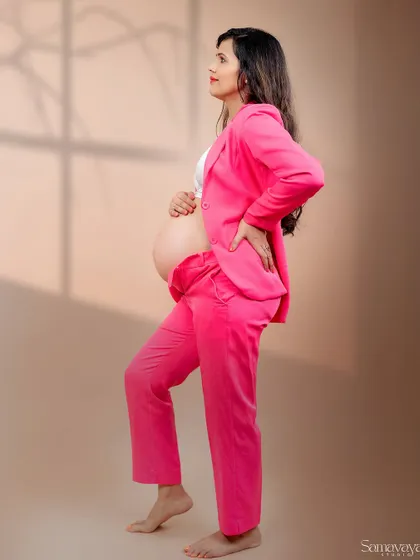 A powerful stance from the mother-to-be in her pink suit. This shot is all about celebrating the strength and beauty of a modern woman.
