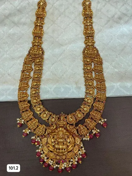 Another variation of the layered silver gold-plated necklace set. This one features beautiful ruby-red stones and pearls, offering a classic bridal color combination.