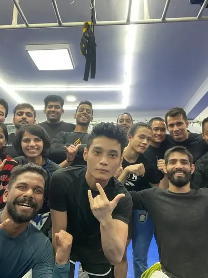 An energetic group photo after an intense No-Gi open mat session.
