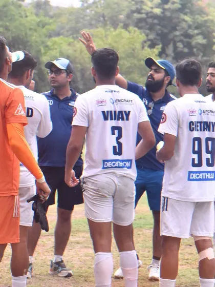 A huddle during a match where the coach provides tactical adjustments to the team, showcasing our dynamic approach to game management.