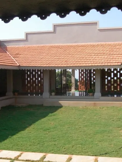 The Ratnagiri Vocational Training Centre (VTC) is designed to generate skilled labor and opportunities in the region. The architecture uses local materials and traditional forms, like sloping tiled roofs and perforated walls, to create an inspiring learning environment.