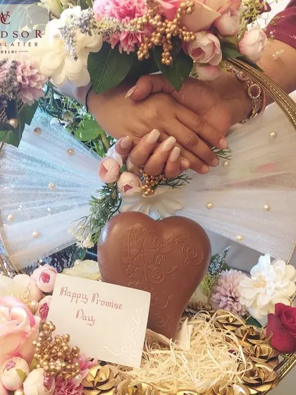 A beautiful Promise Day hamper, featuring a solid milk chocolate heart nestled among flowers and smaller treats, shows how my creations can be part of your most romantic moments.
