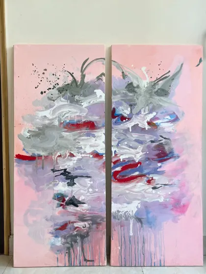 This is a diptych, a set of two paintings designed to be displayed together. The abstract design flows across both canvases, creating a larger, more impactful piece with beautiful drips and splashes of color.