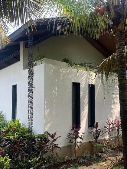 Grove House in Alibaug, nearing completion. The white stucco walls, dark trim, and lush landscaping are starting to come together to create the tropical modern aesthetic we envisioned.