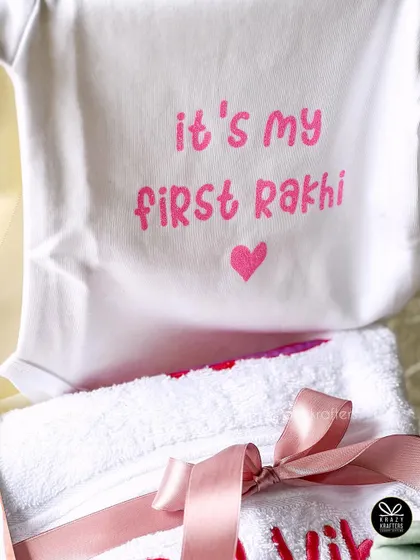 A close-up of the 'It's my first Rakhi' onesie and a personalized towel, perfect for celebrating a little one's first Raksha Bandhan.