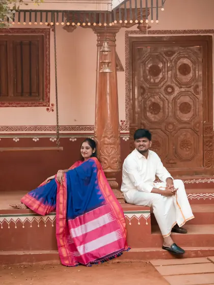 We love capturing timeless traditions. This couple is dressed in beautiful ethnic wear, posing at a rustic, traditional village-style location we arranged.