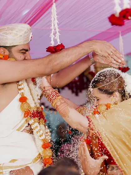 The Talambralu or Akshata ceremony is a beautiful, chaotic, and joyful part of many South Indian weddings. My goal is to freeze that peak moment of action and happiness, showing the couple's interaction amidst the shower of rice and petals.