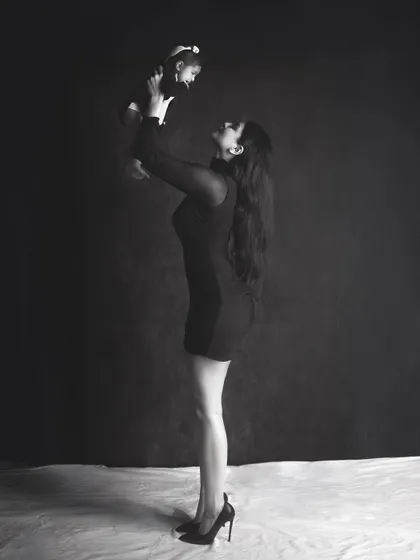 A powerful and elegant portrait of a mother holding her baby. The dramatic lighting and black and white edit create a stunning, high fashion look.