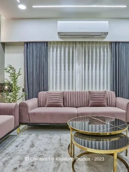 The living room is designed for comfort, with plush sofas, layered curtains, and a neutral color scheme that promotes relaxation.