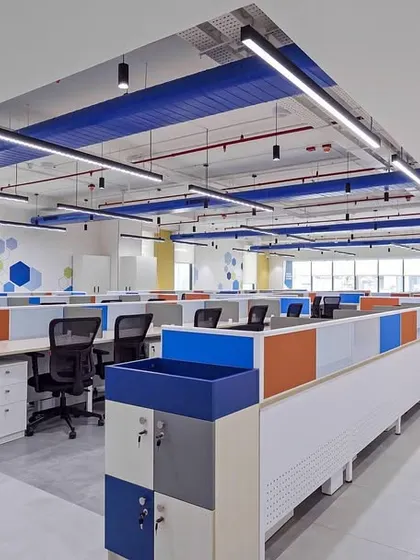 This bright and clean open-plan office uses brand colors to create a cohesive and energetic environment. The layout is designed for efficient movement and clear sightlines, with low partitions on workstations to facilitate team communication.
