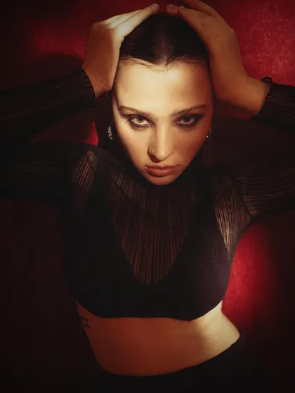 An intense, high-contrast portrait against a dark red background. This kind of dramatic headshot is perfect for showcasing an actor's ability to convey strong emotion.