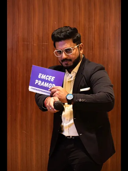Holding my signature "Emcee Pramod" sign at a retirement party. These events are about celebrating a lifetime of achievements, and I make sure they get the honor they deserve.