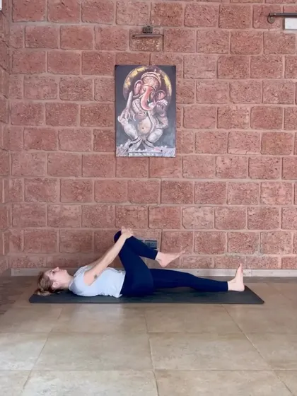 The single-leg variation of Supta Pawanmuktasana. This helps to isolate the stretch and build awareness in the lower back and abdomen.