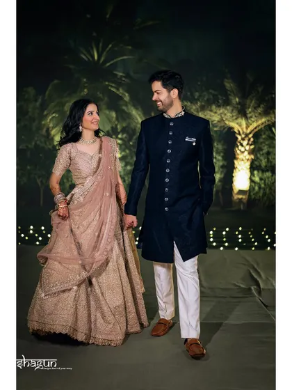 Walking hand-in-hand into their future. A full-length shot of the couple at their reception, looking absolutely radiant.