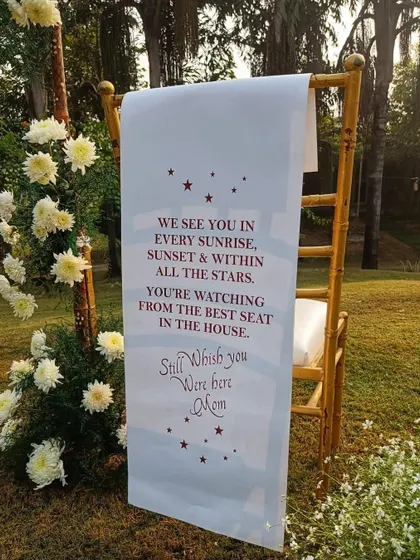 A close-up of the touching message for the tribute corner. The custom-printed scroll reads, "We see you in every sunrise... Still wish you were here Mom," creating a deeply personal and emotional element.