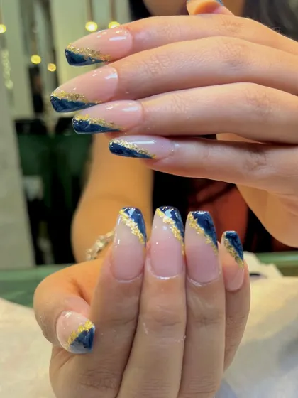 Another angle of the midnight blue and gold foil nails, showing how the gold catches the light.