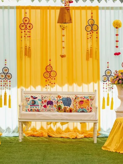 Bright hues and playful details for this Mehendi day. We used colorful dreamcatchers, printed cushions with elephant motifs, and vibrant floral arrangements to create a fun and festive atmosphere.