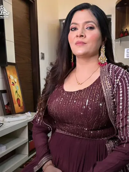 The client is seated and ready for her event. This makeup look is perfect for an anarkali suit, providing a polished and put-together appearance.