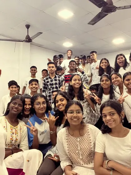 A cheerful group selfie with students dressed in white, marking the beginning of our nine-day Navratri celebration.