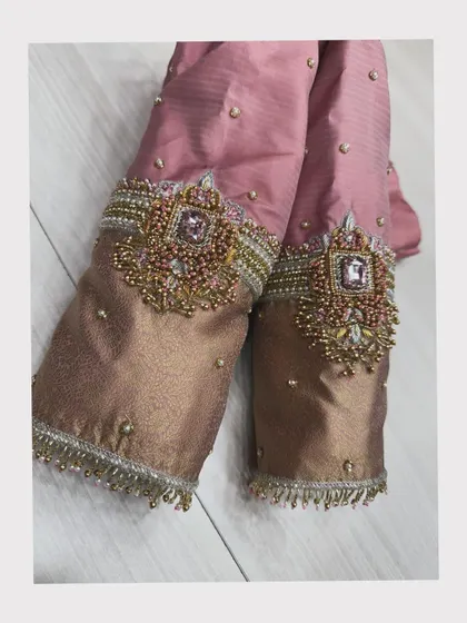 A close-up of heavily embroidered blouse sleeves with beautiful stone work.