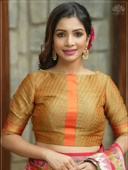 A model pairs her simple, elegant blouse with pearl-studded drop earrings. This shows how my jewellery can add a finishing touch without overpowering an outfit.