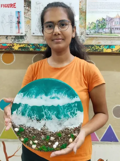 Another happy student with her completed ocean-themed resin art. Our classes provide a supportive environment to explore this popular and rewarding art form.