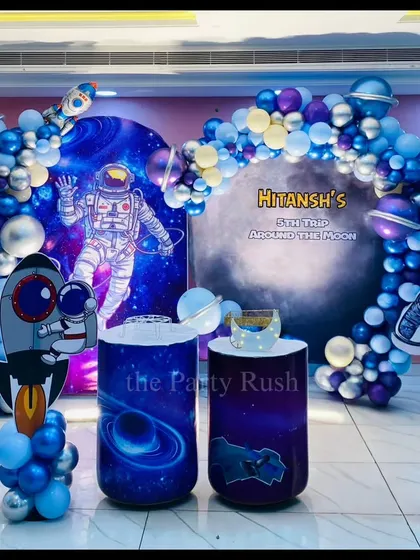 Blast off into fun with this cosmic space adventure I designed for Hitansh's fifth birthday. The decor features astronaut cutouts, galaxy-printed plinths, and a swirling balloon arch of blues and silvers to make the little astronaut's party feel like a trip around the moon.