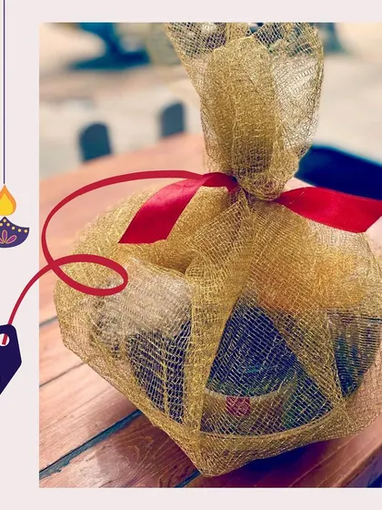 This Diwali, spread the love with a 'Pawsket' for your dog. This gift is wrapped in a beautiful golden net with a red ribbon, priced at just ₹740.