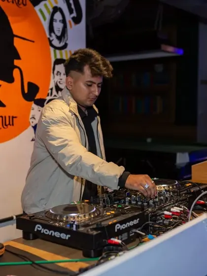 Another view of the DJ at work, set against our signature "Get Sherlocked" wall art. The music is the soul of the party, and my DJs are the heart.