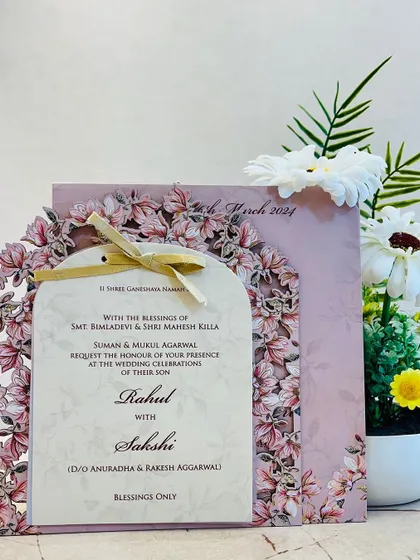 Another view of our elegant laser-cut floral arch invitation, showing the main card and the matching pink envelope.