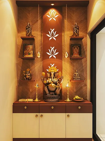 A stunning pooja room design with a large Ganesha idol as the focus. The backlit lotus flower motifs and hanging bells add a traditional and elegant touch.
