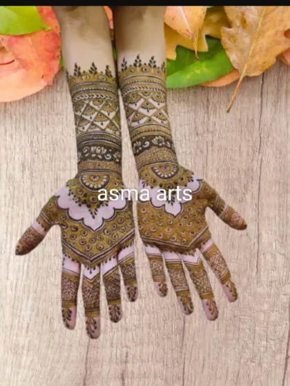 This unique design uses negative space on the back of the hand to create a bold, modern pattern. The contrast between the open space and the detailed geometric work on the forearm is very striking.