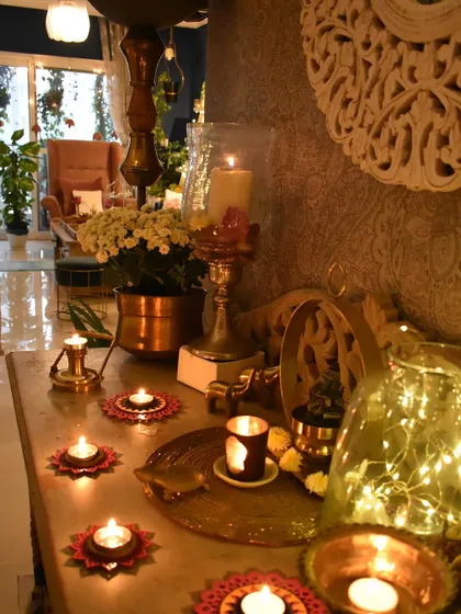 A close-up of the console table decor. The mix of textures and materials, from the carved wood to the brass and glass, is what makes it interesting.