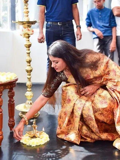 Lighting a lamp at the feet of the Nataraj idol during our studio's opening ceremony. This act symbolizes the dispelling of darkness and the welcoming of knowledge, light, and new beginnings.