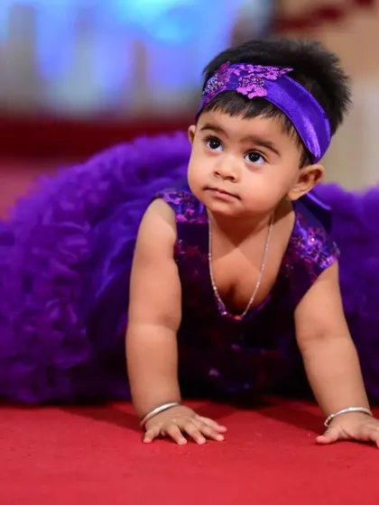 Even while crawling, this dress is all about fun and movement. The layers of soft purple tulle ruffles create a beautiful texture, and the matching embellished headband completes this adorable party outfit.