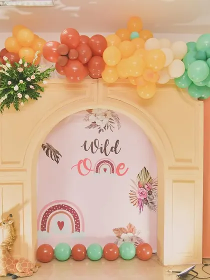 This 'Wild One' setup uses layered 3D panels to create depth, with a hot air balloon and cute animal cutouts.