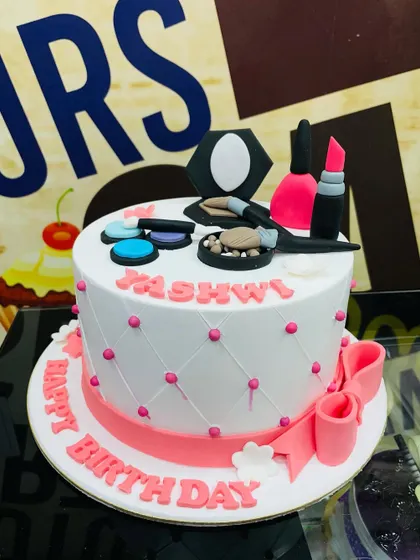 A 2kg makeup lover's dream cake, featuring a quilted pattern and an array of fondant cosmetics on top.