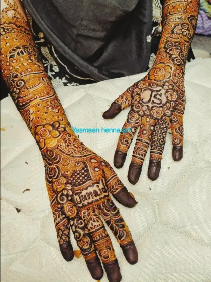 Another view of Junaid and his bride's mehndi, showing the personalized details on both palms.
