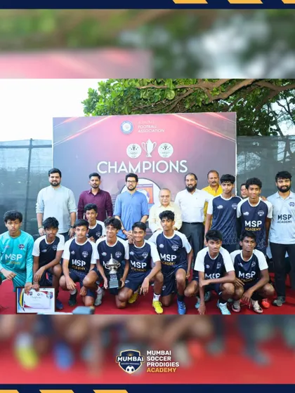 The U15 team poses with officials and their fourth-place trophy at the awards ceremony.