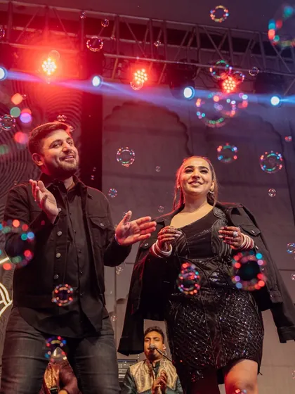 The couple enjoying the bubble-filled dance floor during the Sufi night. A touch of whimsy in a soulful evening.