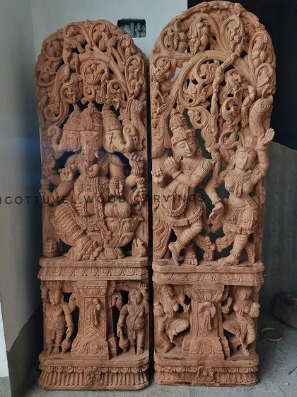 A pair of large, raw wood Jali work panels featuring Ganesha and Radha-Krishna. This shows the pieces before the finishing process, highlighting the pure sculptural form.